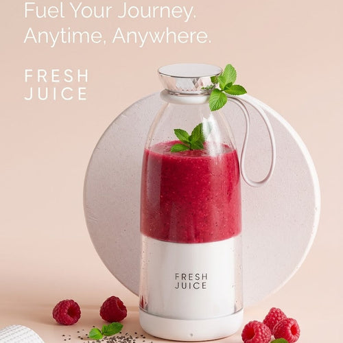 Glass bottle of fresh juice with raspberries on a beige background, featuring the brand 'Fresh Juice'.